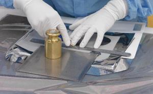 Technician uses templates to finish MLI blankets by hand.